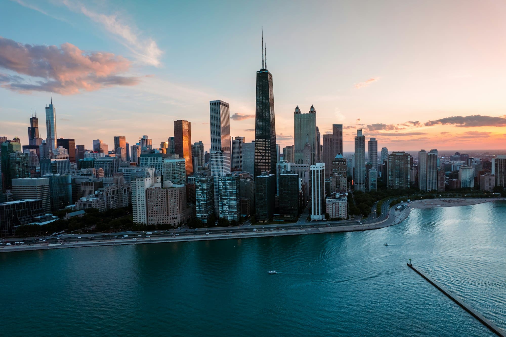 full-bleed photo: Chicago skyline over the lakefront at sunset
